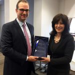 Louis Carter gives Christine Tricoli a Best Practice award at the Federal Reserve Bank of NY